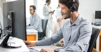 Male call center worker taking a call